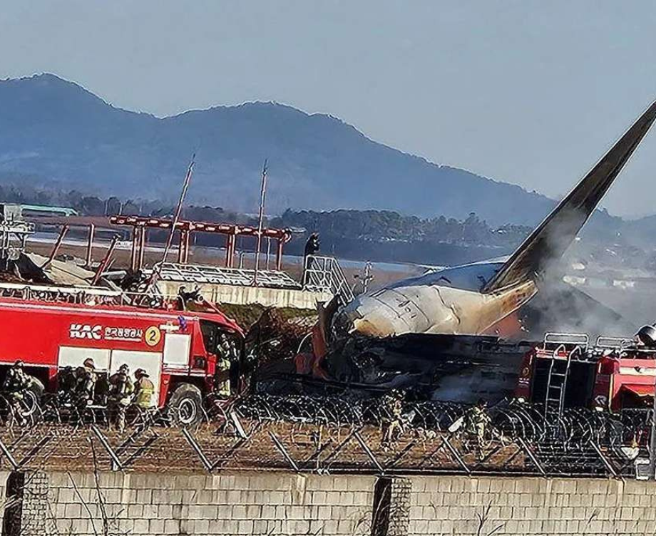 Petugas pemadam kebakaran berada di sekitar pesawat Jeju Air yang keluar landasan pacu di Bandara Internasional Muan, Muan, Provinsi Jeolla Selatan, Korea Selatan, Minggu (29/12/2024). (Foto: ANTARA FOTO/ REUTERS/YONHAP/Spt)6